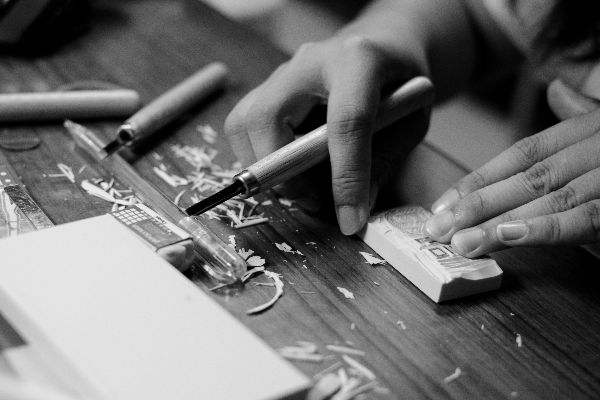 grayscale-photo-of-person-carving-block-1297938
